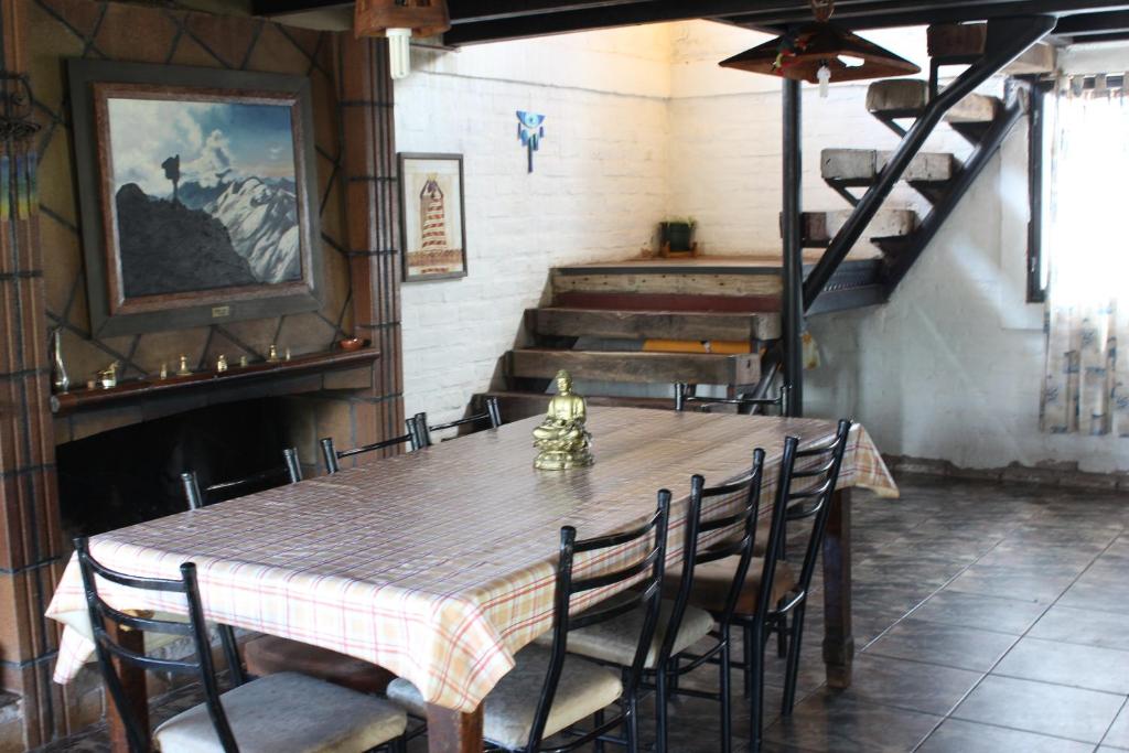 乌斯帕亚塔Samadi Hostel Uspallata的一间带桌椅和楼梯的用餐室