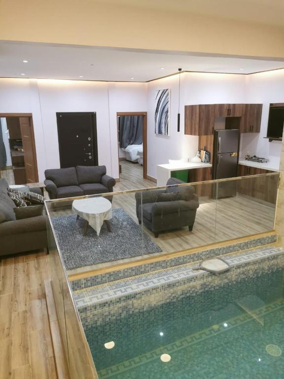 Al RakaPrivate Sand Bond的一间带游泳池的客厅和一间客厅