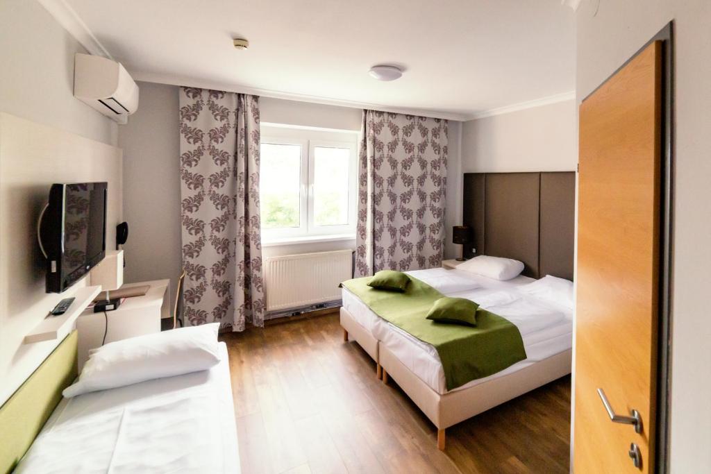 施韦夏特阿里昂机场酒店的酒店客房设有两张床和窗户。