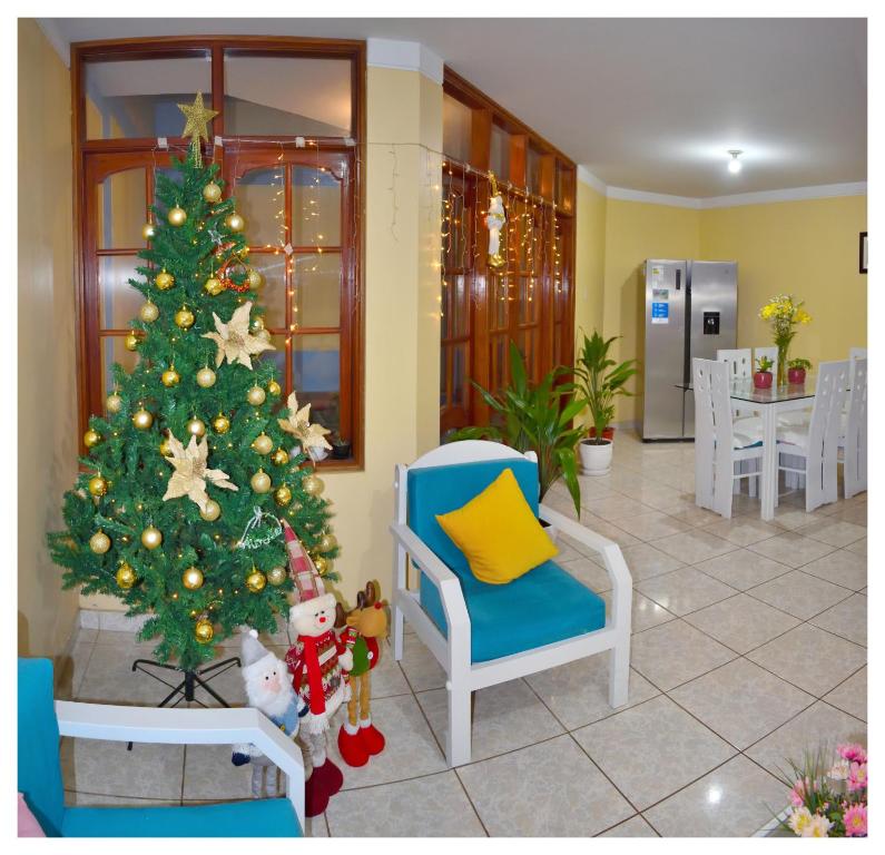 Urbanizacion Buenos AiresHospedaje La Casa Blanca的客厅里的圣诞树,配蓝色椅子