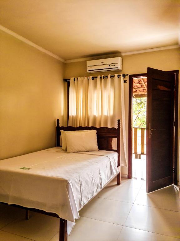 伦索伊斯Vila Sancar Pousada的卧室配有一张床和空调