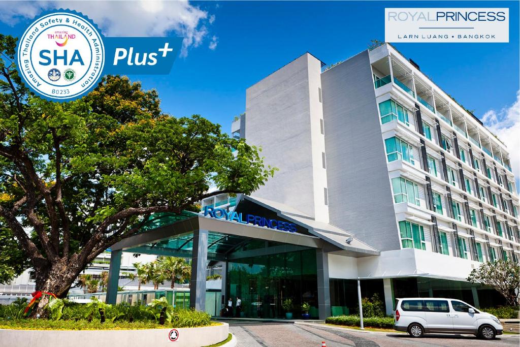 曼谷皇家公主兰朗酒店 - SHA Extra Plus的停在大楼前的白色汽车