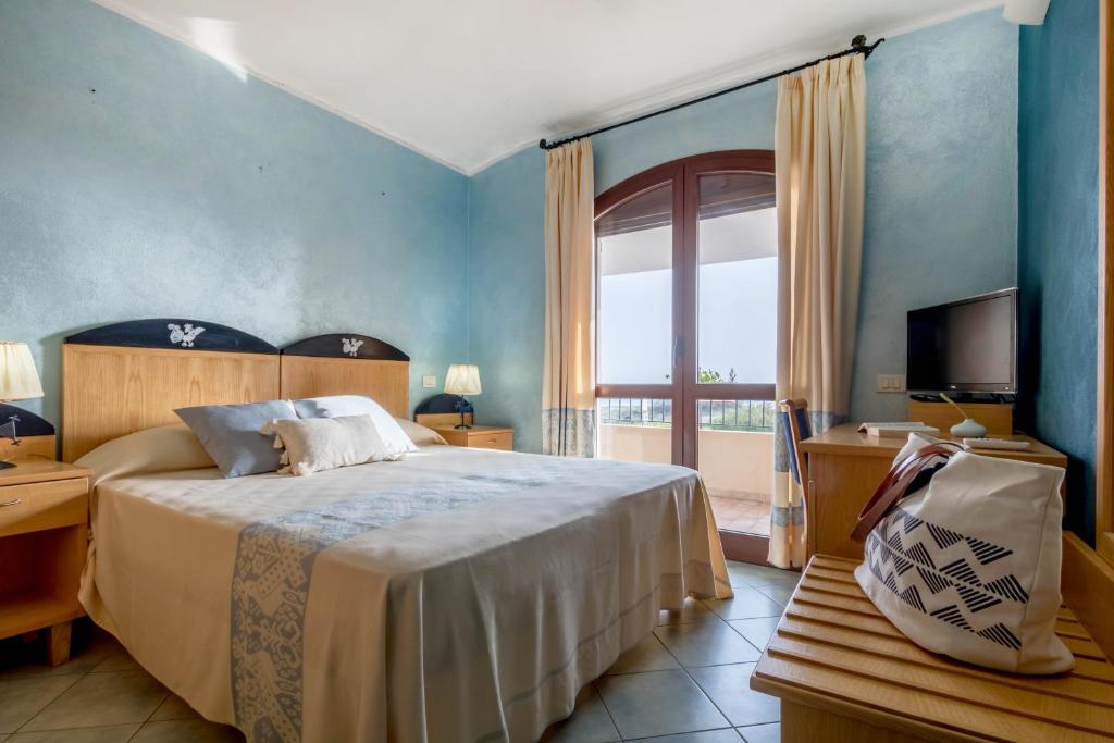 索拉纳斯Hotel Villa del Mare Solanas的一间卧室设有一张床和一个大窗户
