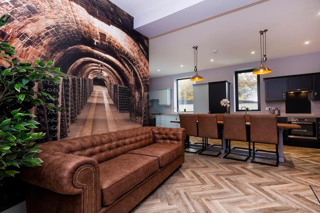 韦克菲尔德BOOTique House - Luxury Group Accommodation in Wakefield的带沙发和砖墙的客厅