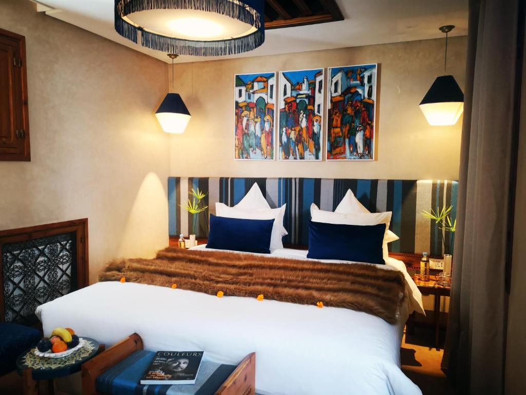 拉巴特里亚德卡拉的一间卧室配有一张带蓝色和白色枕头的床