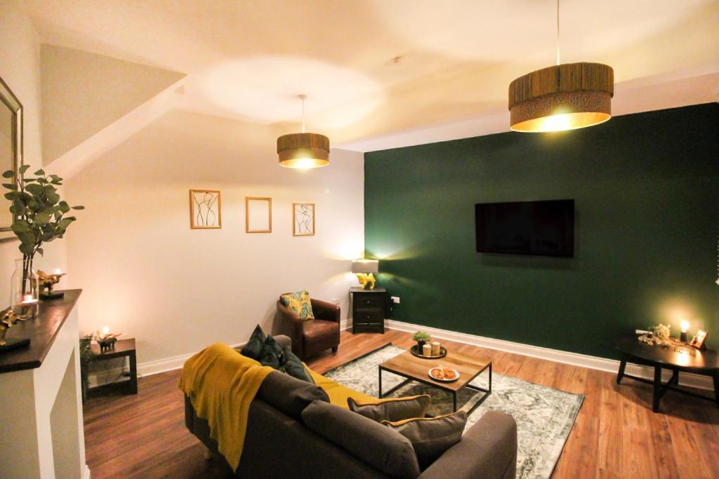 诺丁汉3 Bedroom City Centre Townhouse的带沙发和绿色墙壁的客厅
