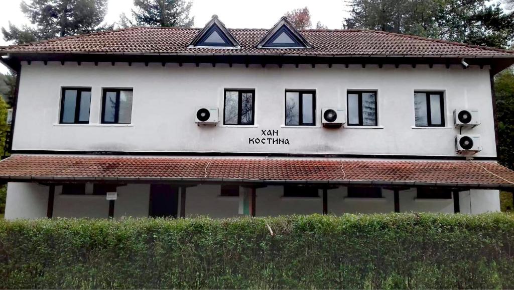 里巴里卡ХАН КОСТИНА - HAN KOSTINA的白色的房子,上面有标志,说明为什么要重新开始