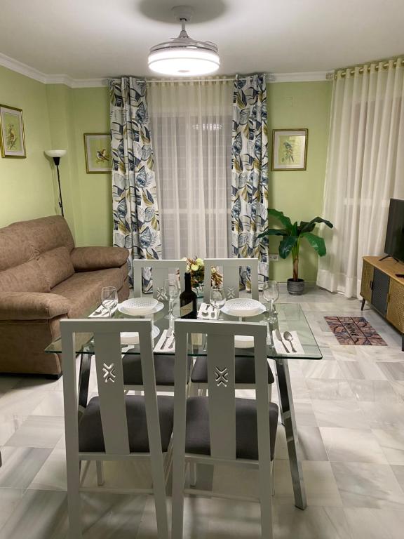 赫雷斯-德拉弗龙特拉Apartamento céntrico “Los Pajaritos” con garaje.的客厅配有餐桌和椅子