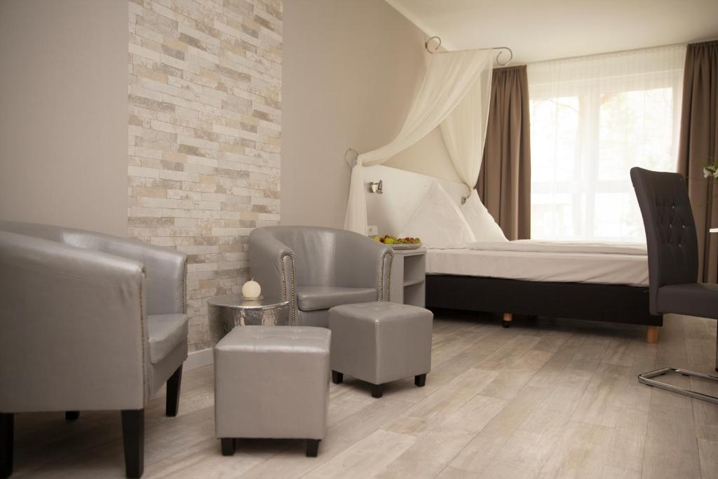 柏林柏林基兹潘森酒店的一间卧室配有床、椅子和窗户