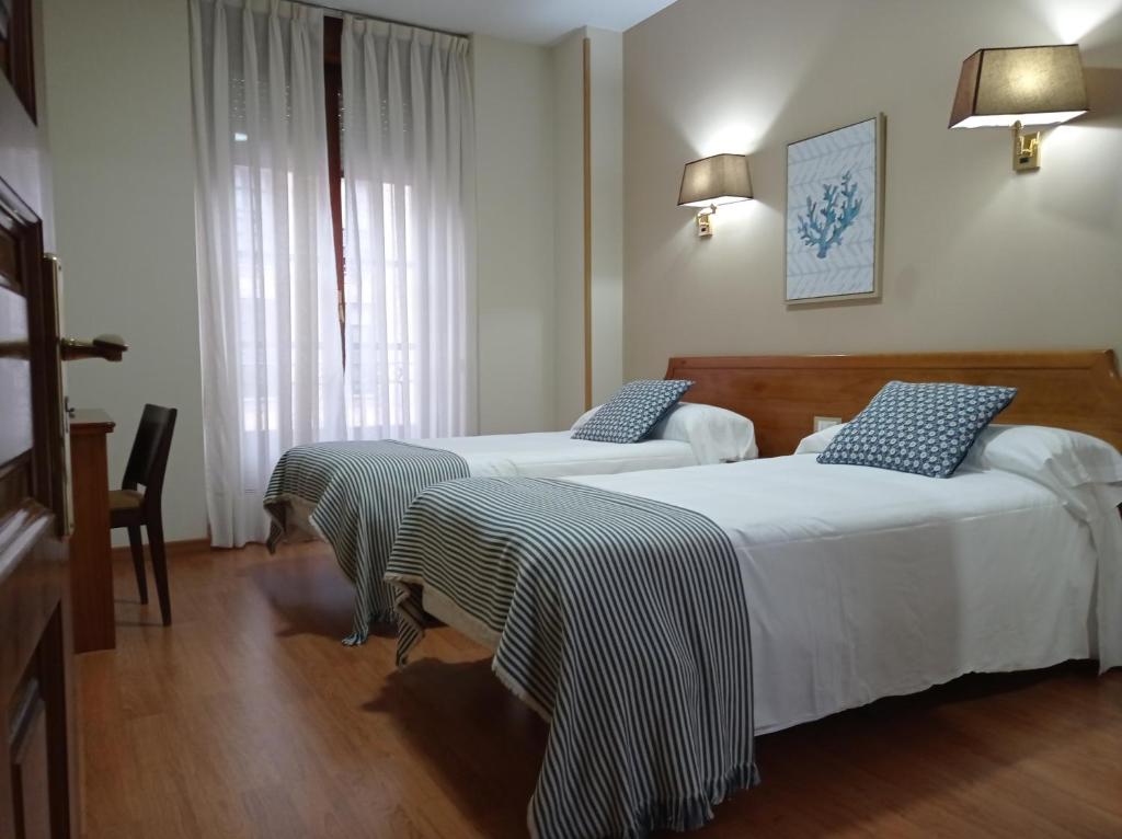 坎加斯-德奥尼斯罗斯罗布雷斯酒店的酒店客房设有两张床和窗户。