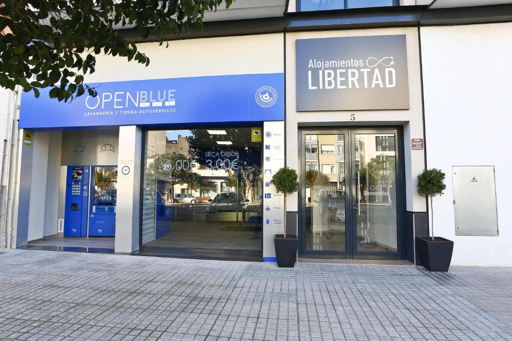 耶克拉Alojamientos Libertad的门开的建筑物前的商店