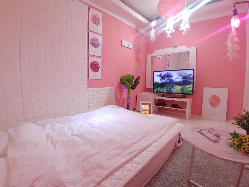首尔Spring Light的一间卧室配有一张床、一张桌子和一台电视。