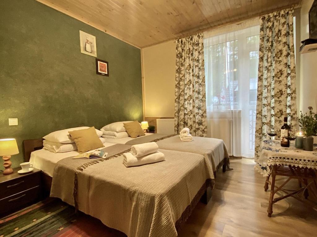 斯基希德尼萨Садиба Оберіг的一间卧室设有两张床和窗户。