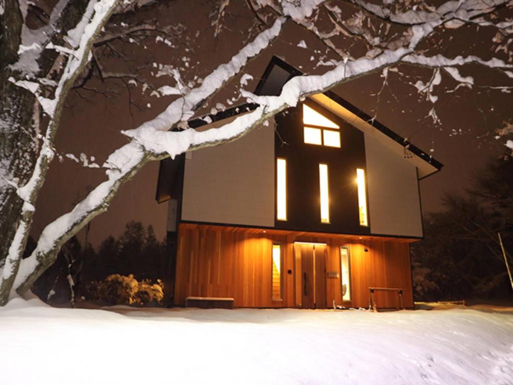 白马村Hakuba Hokujo的小屋在晚上被雪点燃