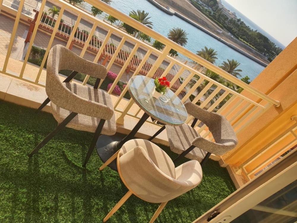 阿卜杜勒国王经济城إطلالة بحرية عوائل فقط KAEC Star Sea View的水景阳台配有一张桌子和两把椅子