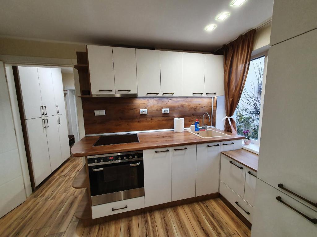 鲁塞Malavi KI top center studio Ruse的厨房配有白色橱柜、水槽和炉灶。