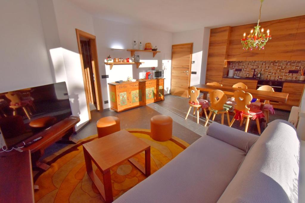 摩德纳迪-坎皮格里奥PATASCOSS TERRAZZA sulle DOLOMITI的客厅配有沙发和桌子