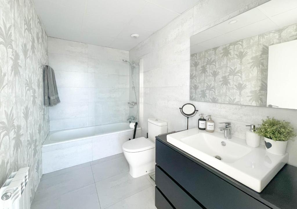 萨拉戈萨Ático mejores vistas al Pilar jacuzzi y garaje的白色的浴室设有水槽和卫生间。