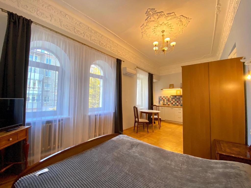 第聂伯罗Ermitage Apt, Апартаменти в Центрі Дніпра的一间卧室配有一张床、一台电视和一张桌子