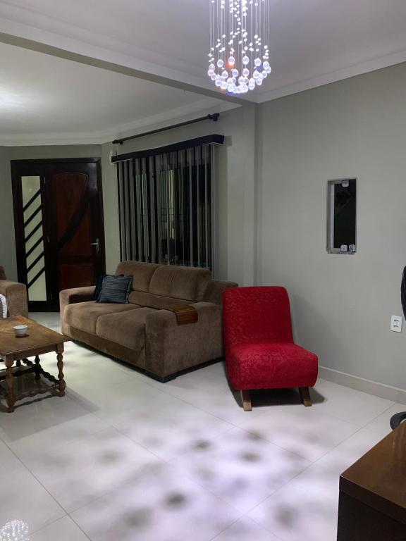 伊达贾伊Casa Oliveiras的带沙发和红色椅子的客厅