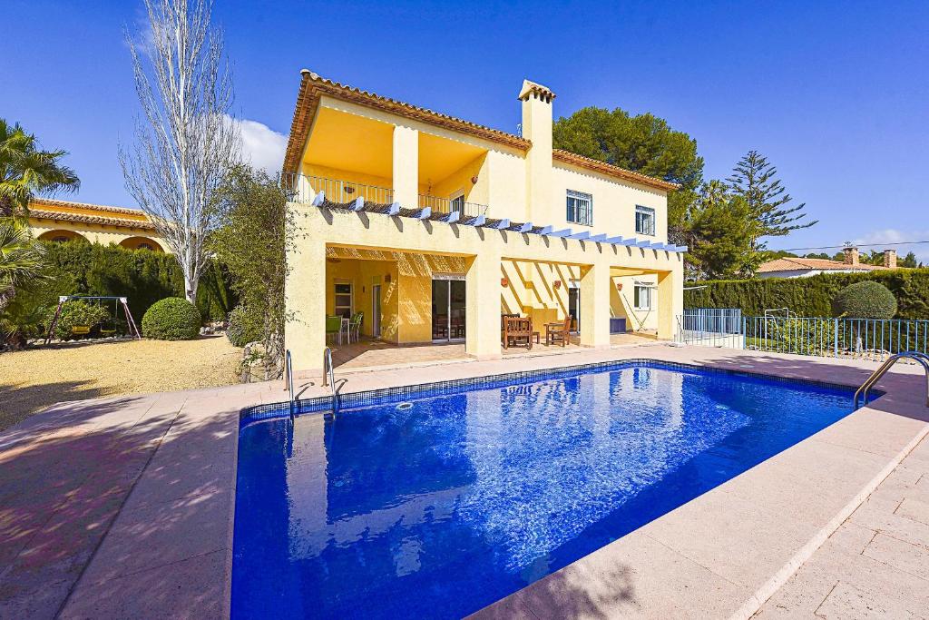 卡尔佩Villa Gio - PlusHolidays的房屋前有游泳池的房子