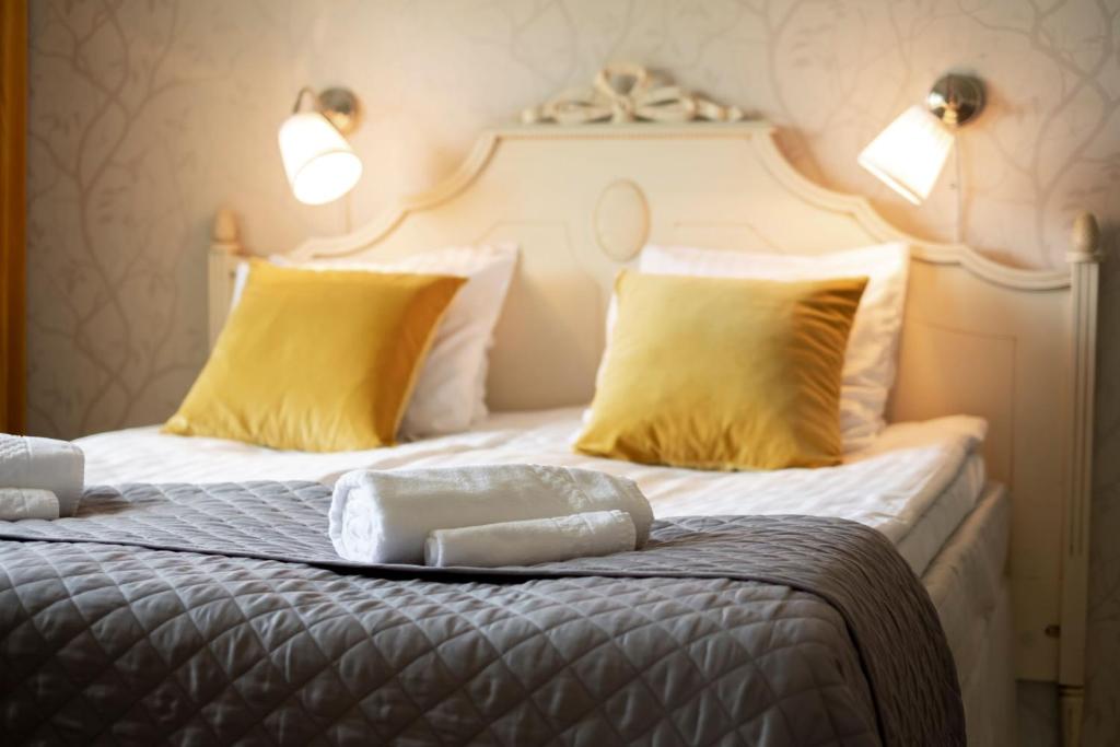 凯乌鲁IK Hotel & Camping的一间卧室配有两张带黄色枕头的床
