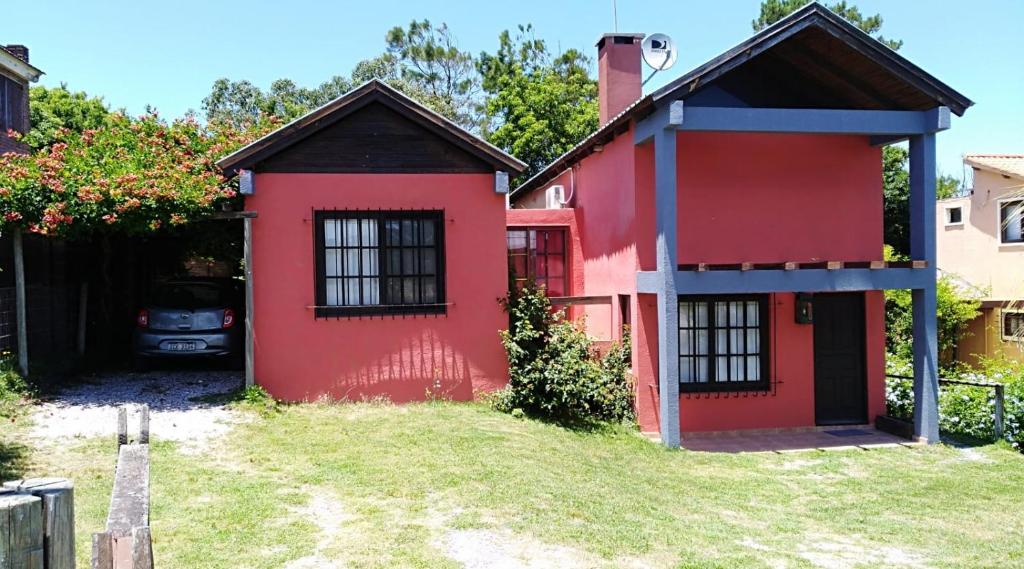 Playa VerdeCasa Roja的旁边一辆汽车停着的红色房子