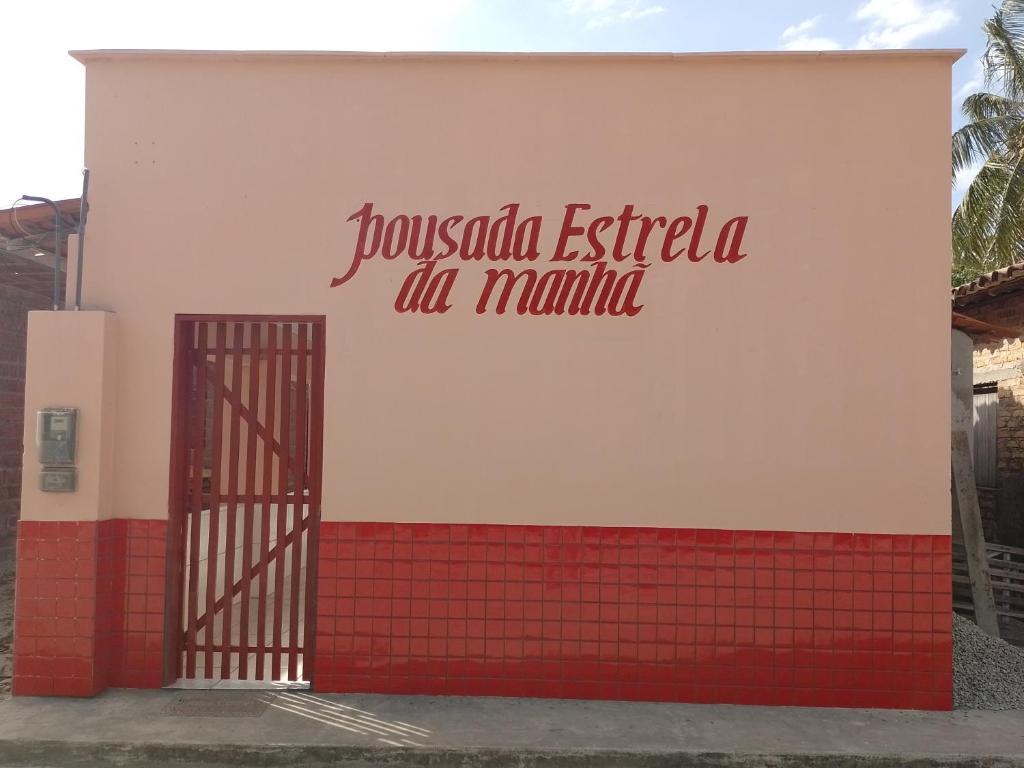 圣阿马鲁pousada estrela da manhã的一座有红色和白色墙壁的建筑,设有大门
