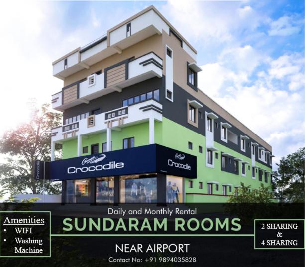 哥印拜陀Sundaram Rooms的前面有标志的建筑