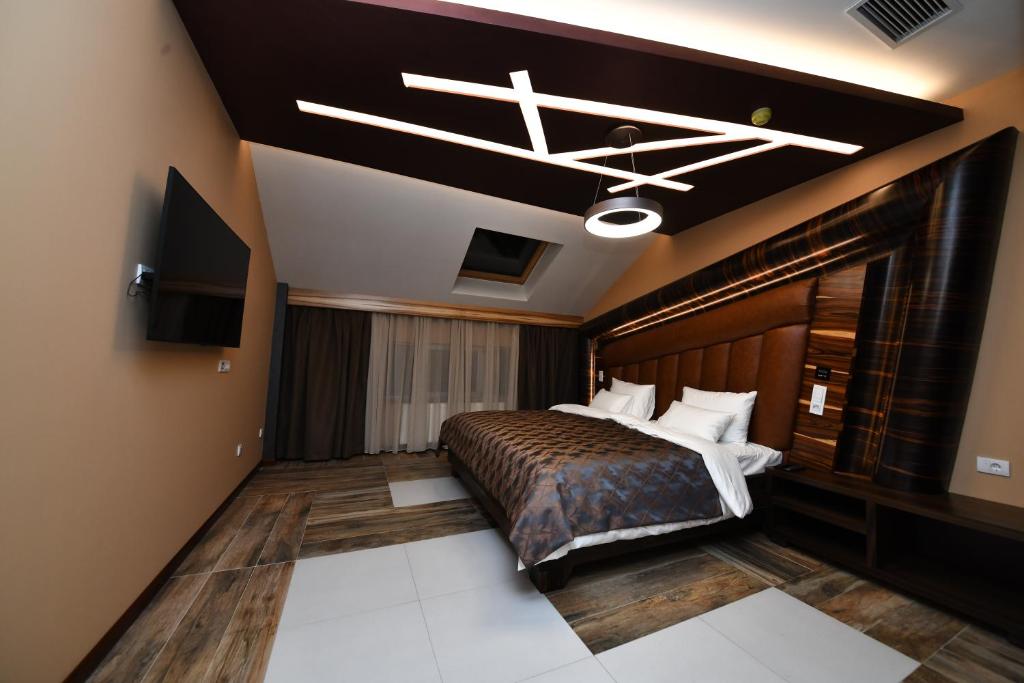 洛兹尼察Hotel Havana Loznica的配有床和电视的酒店房间