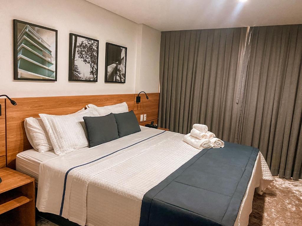 伊泰帕瓦Apart-hotel Granja Brasil Itaipava的一间卧室设有一张大床和一个窗户。