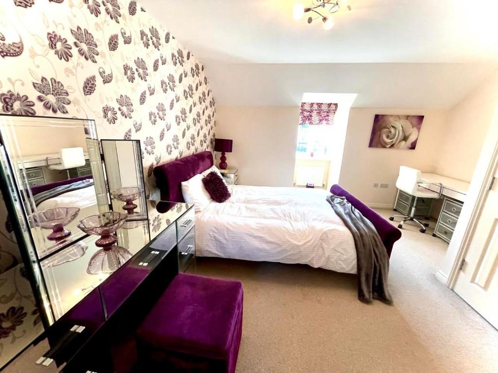 格雷斯瑟罗克Lakeside Stylish 3 Bedroom House的一间卧室配有一张带紫色家具和镜子的床
