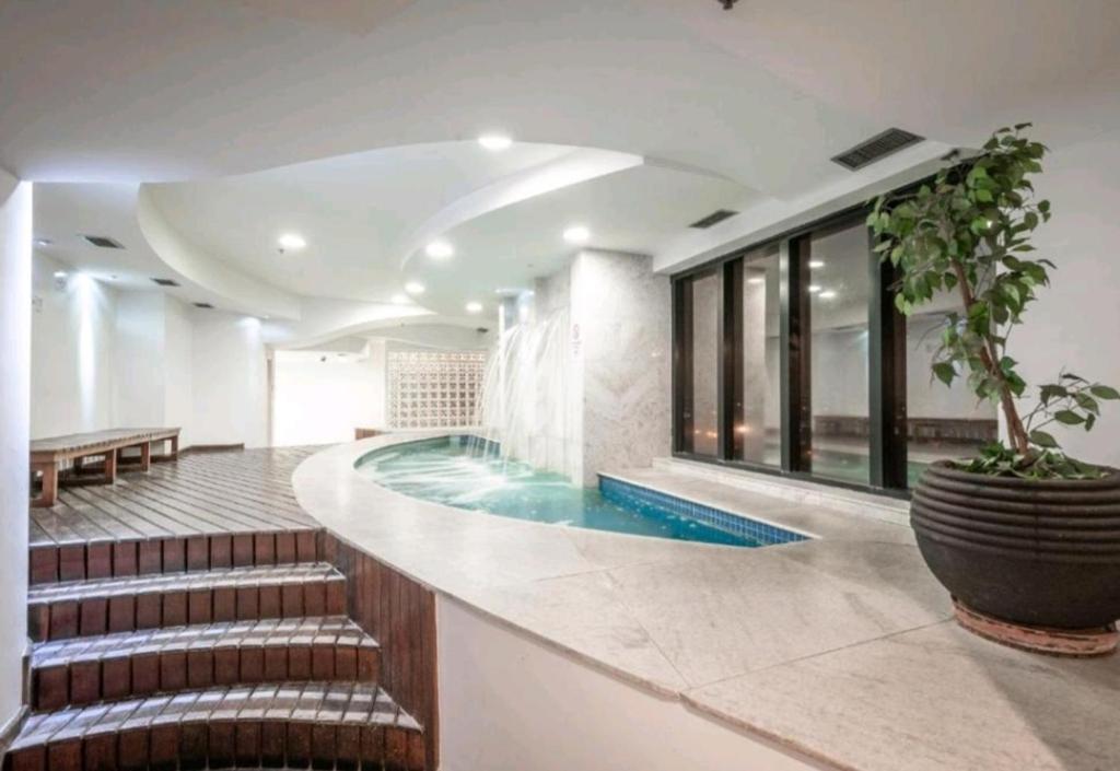 瓜鲁柳斯Guarulhos flat services, aeroporto的一座带楼梯的大楼内的游泳池,通往游泳池