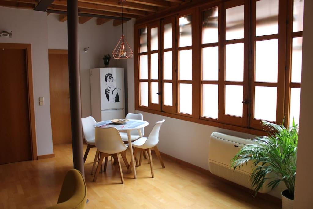 托莱多La Casa de Sillería的一间带桌椅和窗户的用餐室