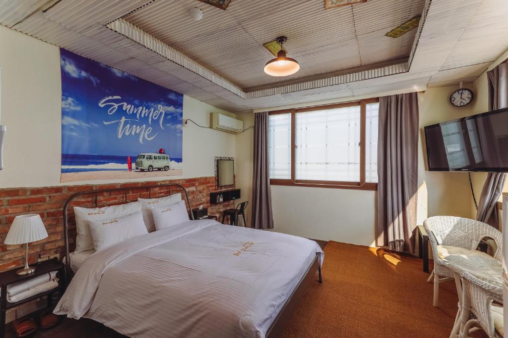蔚山蔚蓝海景酒店的一间带大床和电视的卧室