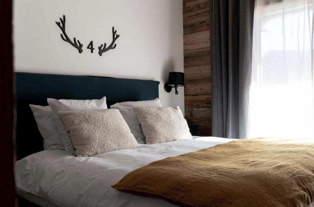 莱热Chalets Alaska的一间卧室配有一张带蓝色床头板和枕头的床。