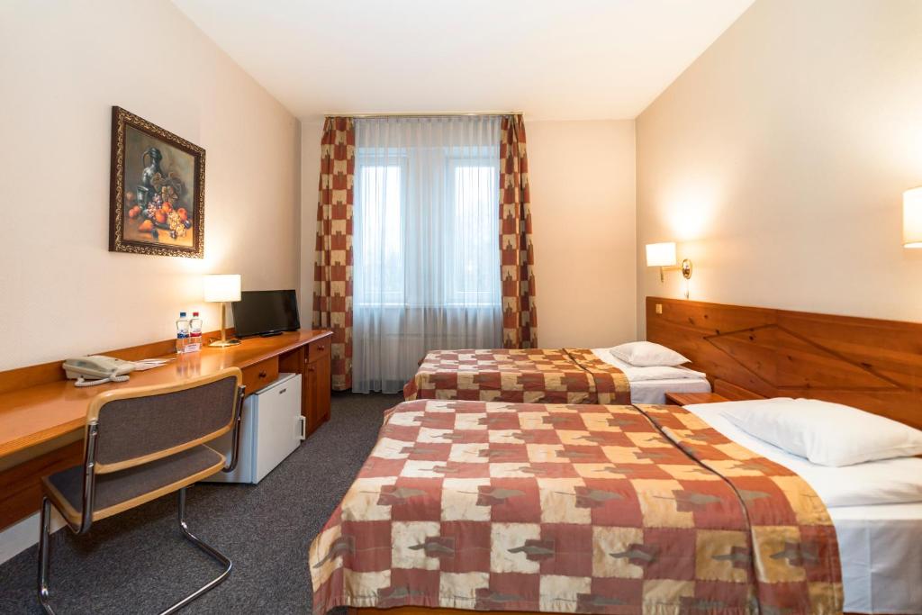 里加科隆纳布里格塔酒店的酒店客房配有两张床和一张书桌