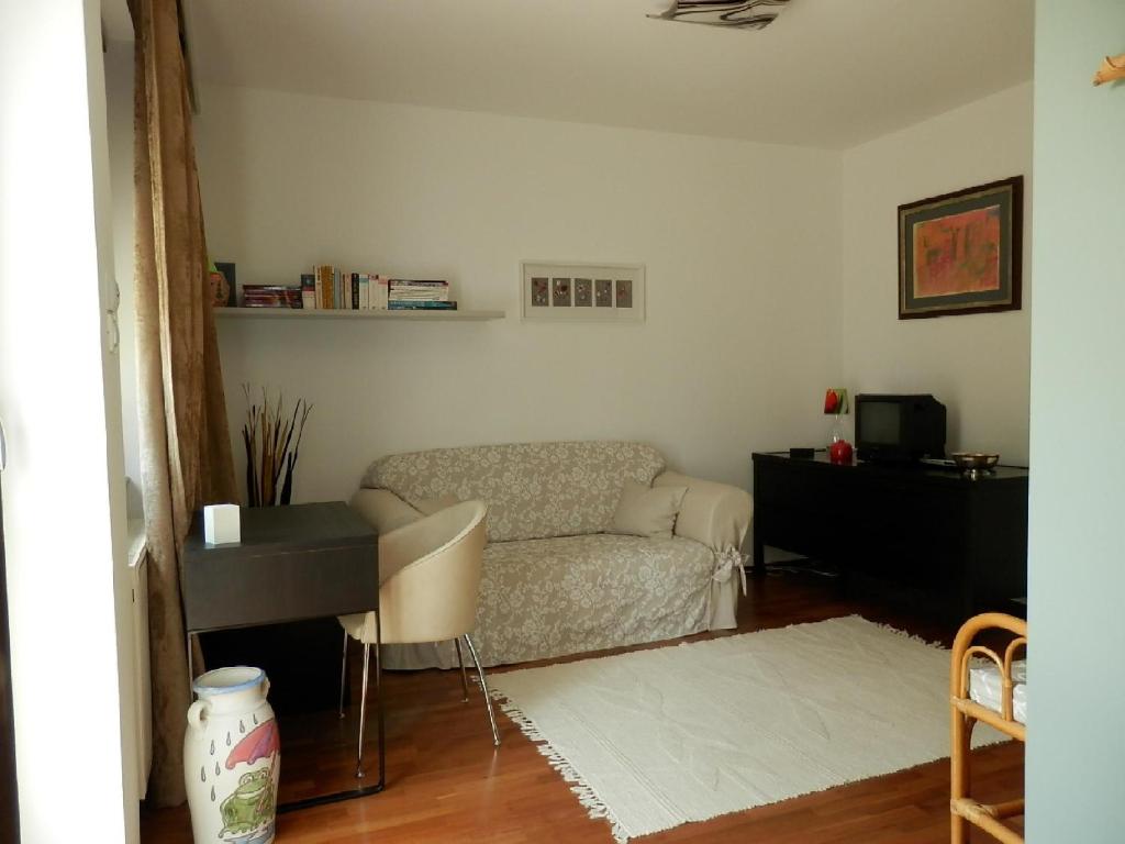 布达厄尔什斯奇公寓的客厅配有沙发、桌子和钢琴