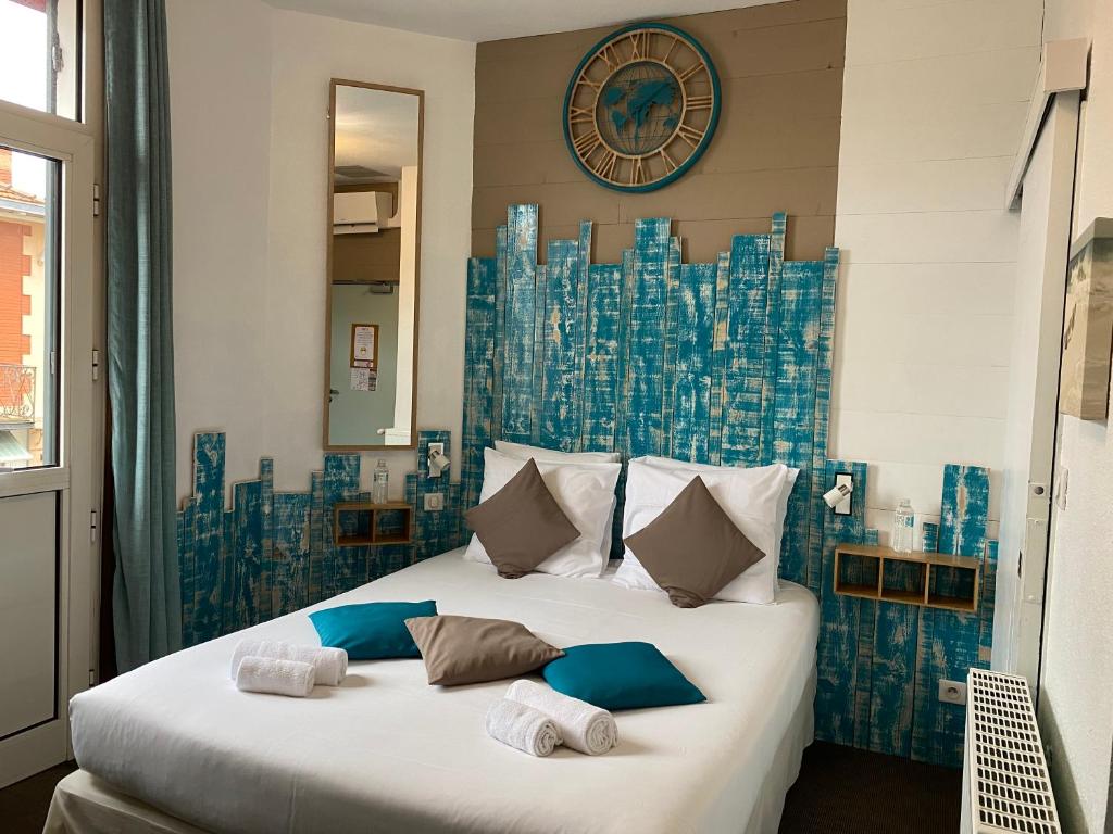 阿卡雄Hôtel Familial L'Ostréi的一间卧室配有一张带蓝白色床单的大床
