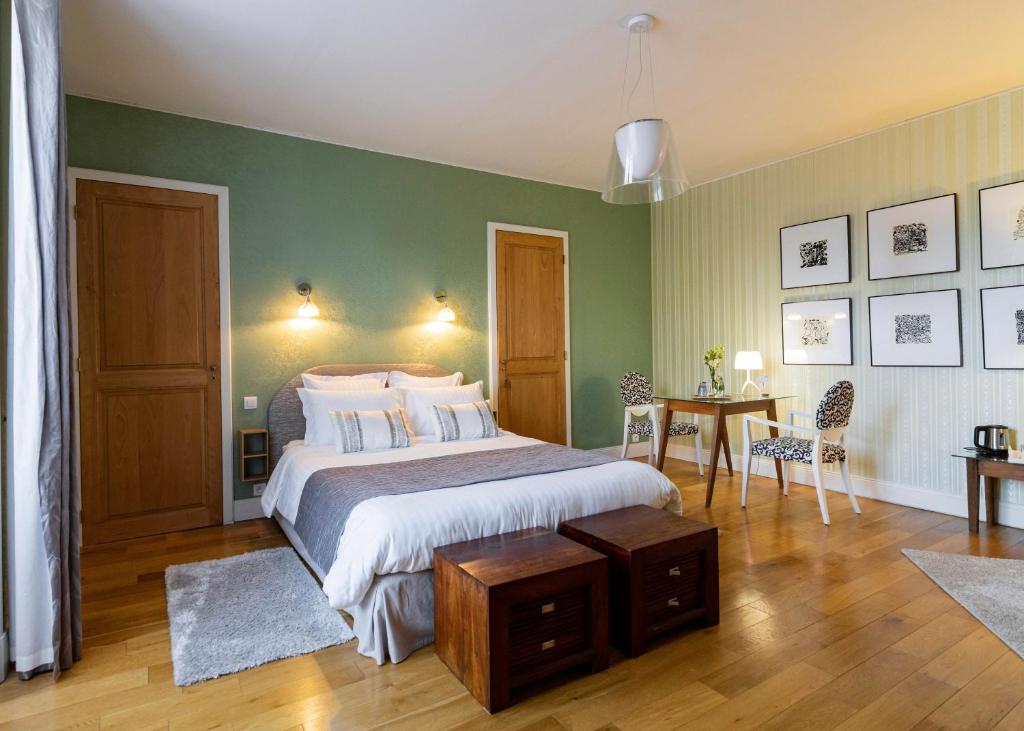 普瓦捷Clos des Moulins的卧室配有一张床和一张桌子及椅子