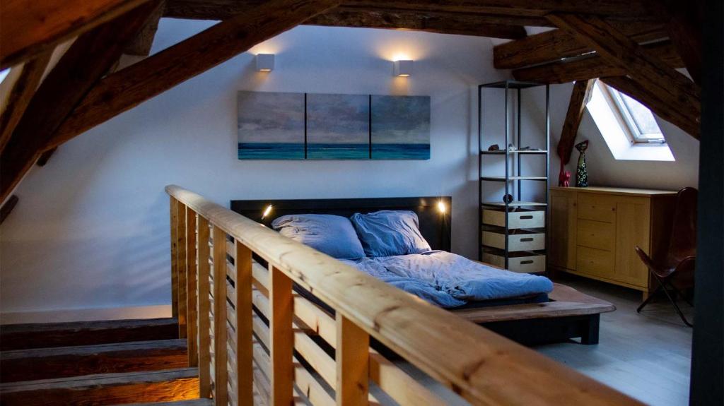 内卡河畔霍尔布Schloss Mühlen的一间带一张床的卧室,位于带楼梯的房间