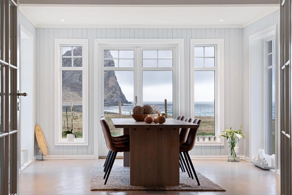 UnnstadUnstad Arctic Resort的一间带桌椅和窗户的用餐室
