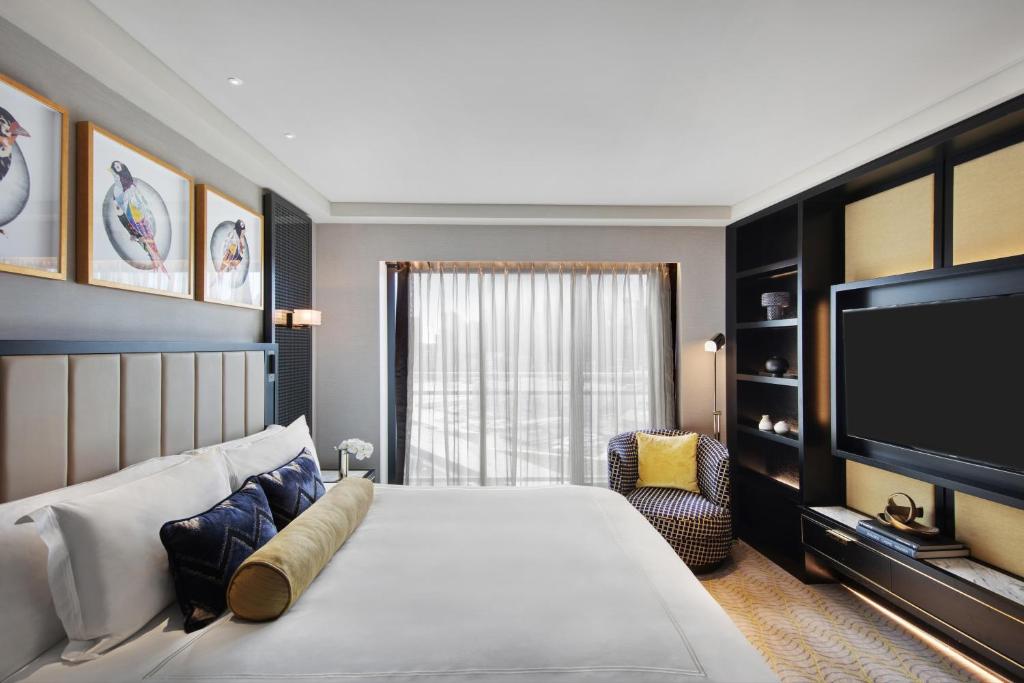 悉尼The Star Grand Hotel and Residences Sydney的一间卧室配有一张大床和一台平面电视