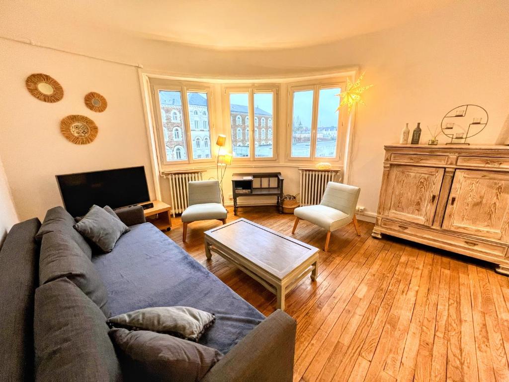南特Appartement de Charme de 75m², Lumineux et Calme的客厅配有沙发和桌子