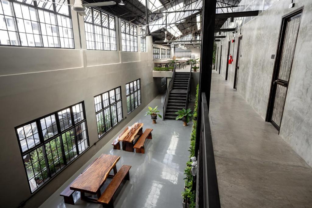 清迈Premier Hostel Chiang Mai的一组长椅,位于一栋带窗户的建筑内