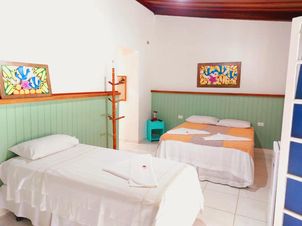 乌巴图巴Pousada Capim Melado的一间卧室,配有两张床