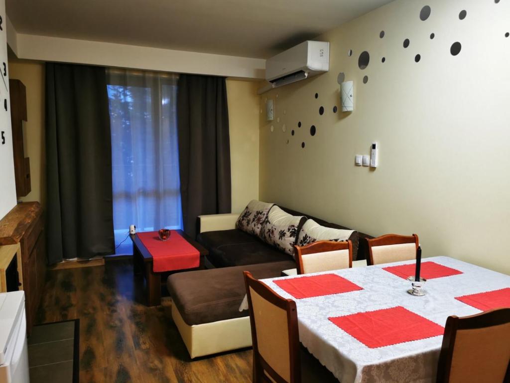 班斯科Grand Bansko 1 Family apartment B206的客厅配有桌子和沙发