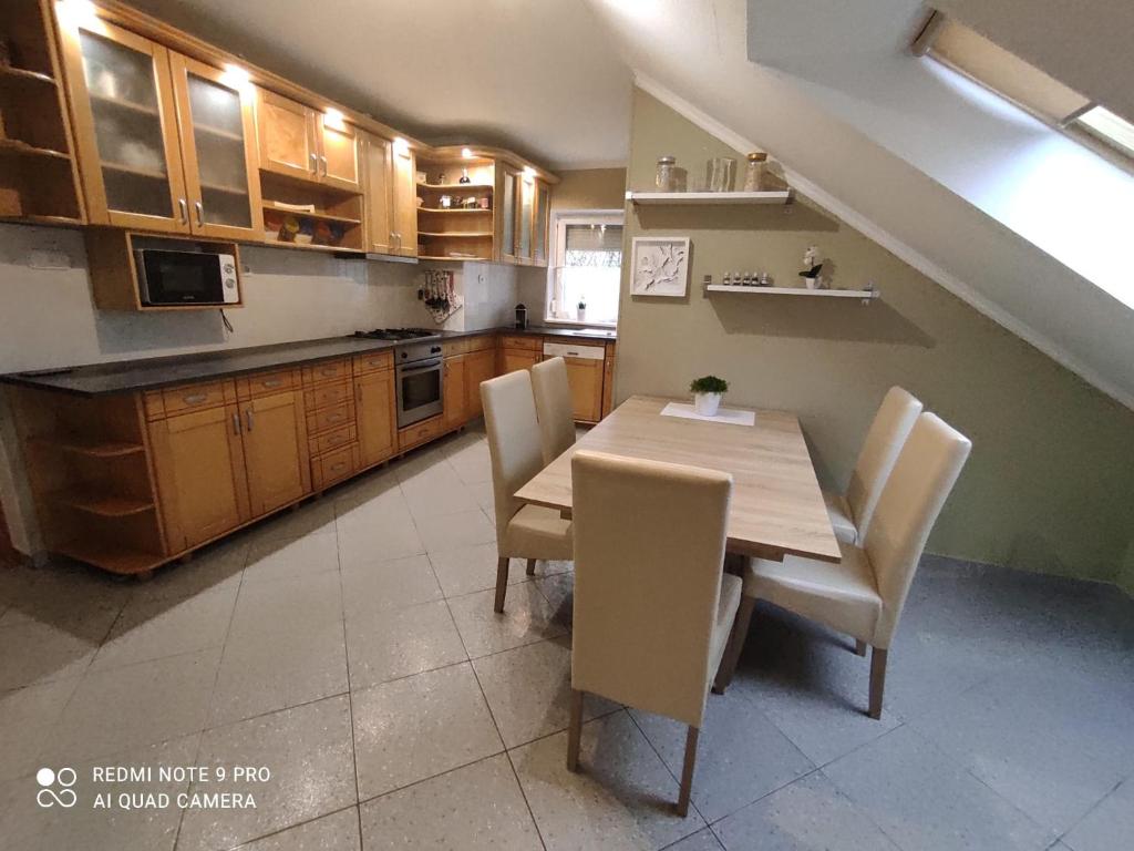巴拉顿菲赖德Felhő Apartman的厨房配有木桌和椅子