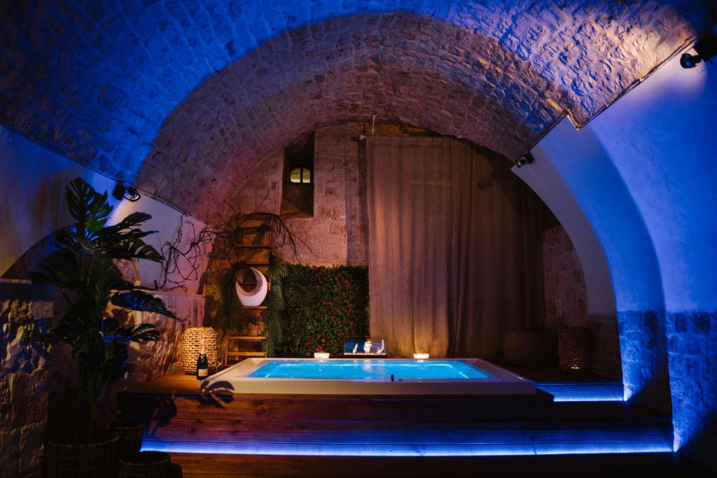 卡斯特拉纳格罗泰Apulia Suite的砖墙客房内的浴缸