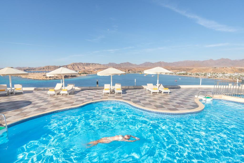 沙姆沙伊赫Albatros Sharm Resort - By Pickalbatros的在游泳池游泳的人